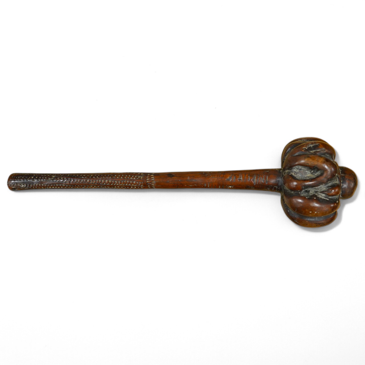 A 19th century Fiji carved hardwood throwing club, Ula, 40cm long, swollen head divided into nine segments, the handle carved with zigzag decoration and incised lines. Condition - good.